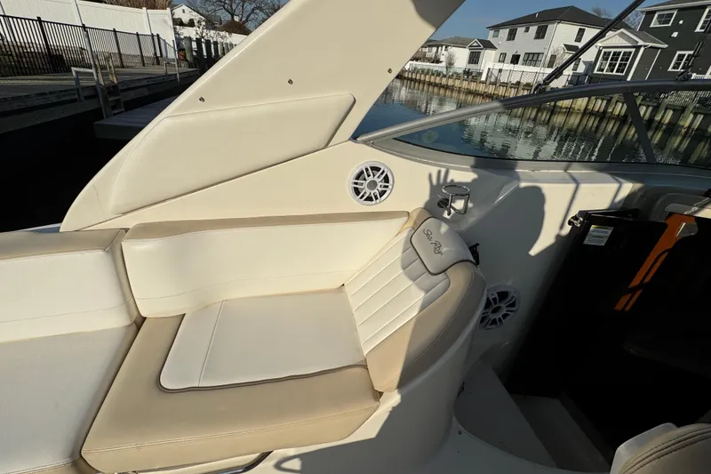 Slide: The Image of Interior of 2013 Sea Ray 280 Sundancer boat with beige seating and waterfront view. - 11