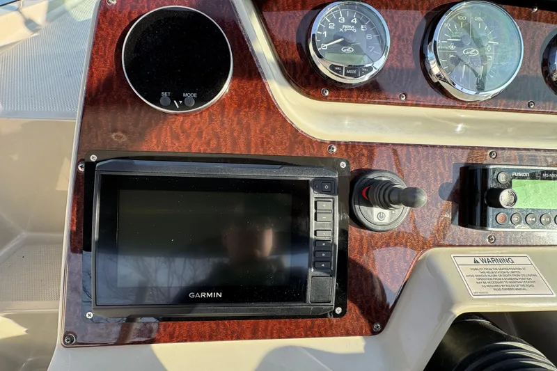 Slide: The Image of Dashboard of 2013 Sea Ray 280 Sundancer with Garmin navigation system and gauges. - 14