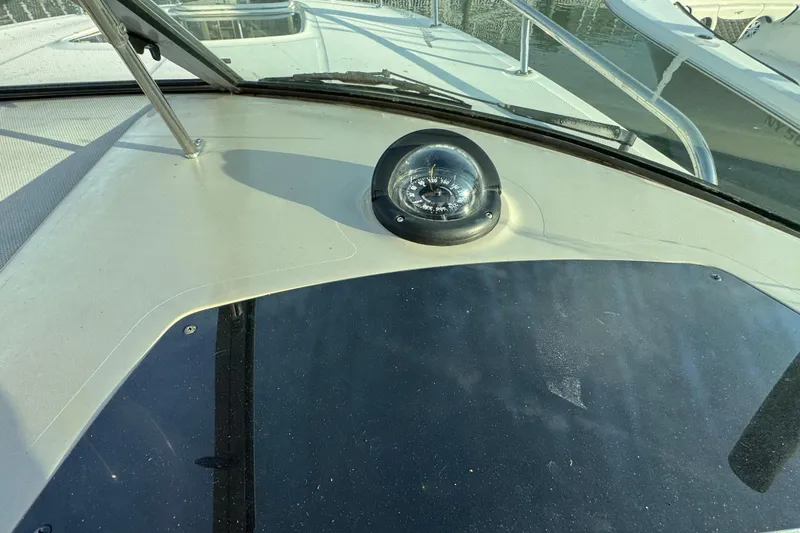 Slide: The Image of 2013 Sea Ray 280 Sundancer boat dashboard with compass and windshield view. - 15