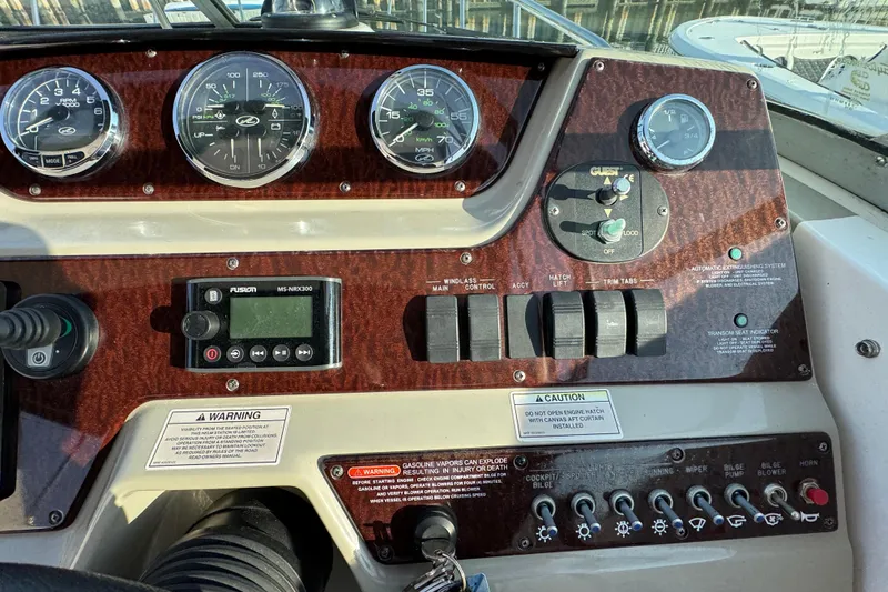 Slide: The Image of Dashboard of a 2013 Sea Ray 280 Sundancer boat with gauges and controls. - 16