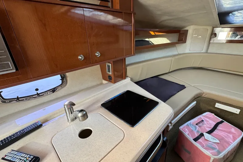 Slide: The Image of Interior of 2013 Sea Ray 280 Sundancer with kitchenette and seating area. - 21