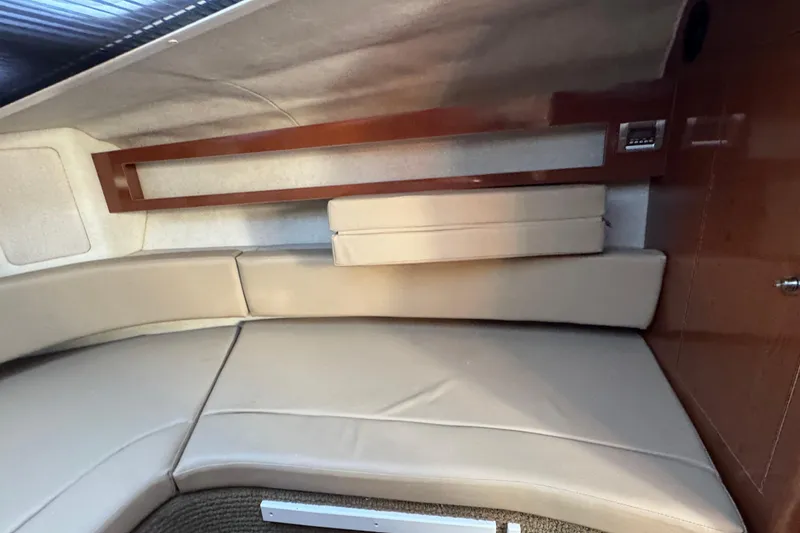 Slide: The Image of Interior cabin of 2013 Sea Ray 280 Sundancer with beige seating and wooden accents. - 24