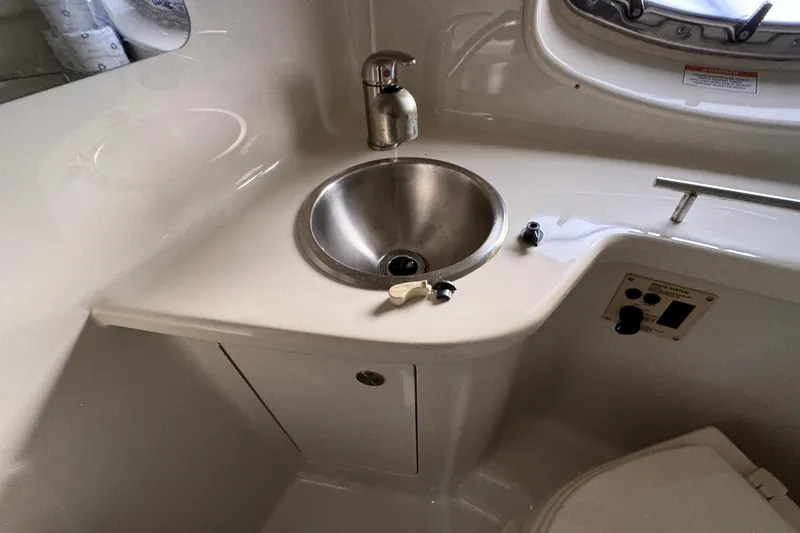 Slide: The Image of Interior of 2013 Sea Ray 280 Sundancer with sink and faucet in cabin area. - 29