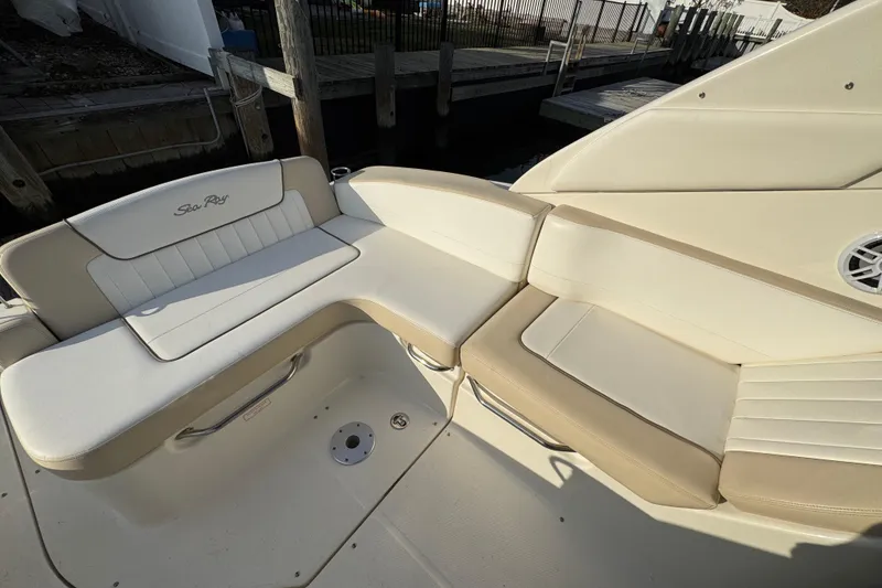 Slide: The Image of 2013 Sea Ray 280 Sundancer boat seating area with beige and white upholstery. - 7