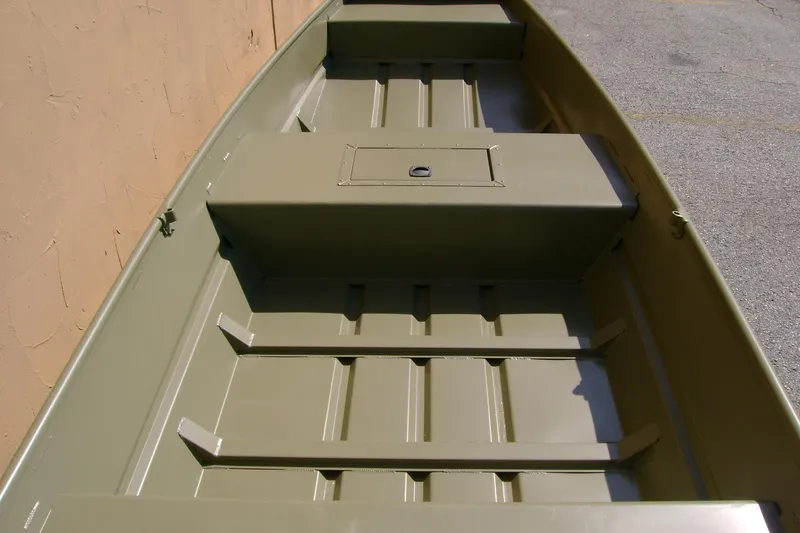 Slide: The Image of 2026 Tracker Grizzly 15 Jon boat interior, featuring durable seating and storage compartments. - 2