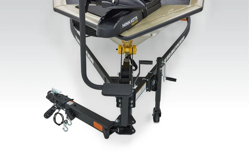 Slide: The Image of 2026 Tracker Pro Team 175 boat storage compartment with carpeted interior and secure latch. - 11