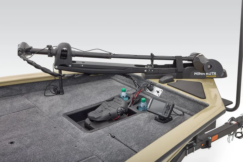 Slide: The Image of 2026 Tracker Pro Team 175 boat storage compartment with open lid on carpeted floor. - 15