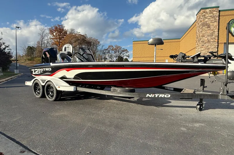 Slide: The Image of 2026 Nitro Z21 XL Pro boat on trailer, parked outdoors under a blue sky. - 81