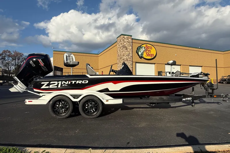 Slide: The Image of 2026 Nitro Z21 XL Pro boat parked outside Bass Pro Shops under a cloudy sky. - 82