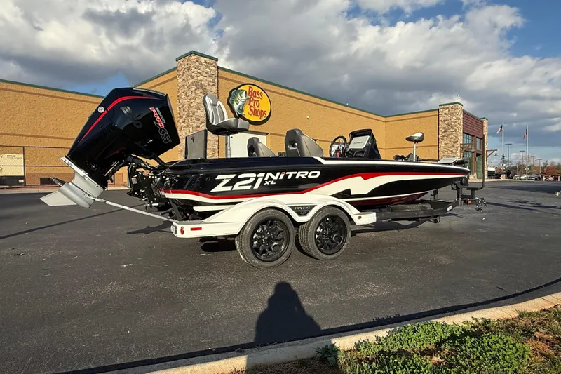 Slide: The Image of 2026 Nitro Z21 XL Pro boat parked outside Bass Pro Shops under cloudy sky. - 83