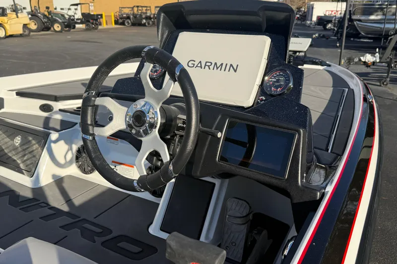 Slide: The Image of 2026 Nitro Z21 XL Pro boat dashboard with Garmin navigation system and steering wheel. - 85