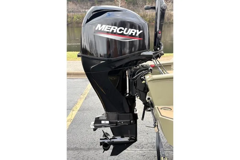 Slide: The Image of Outboard motor on a 2026 Tracker Grizzly 1756 T Marsh boat, parked near water. - 10