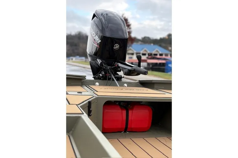 Slide: The Image of 2026 Tracker Grizzly 1756 T Marsh boat with Mercury outboard motor and red fuel tank. - 12