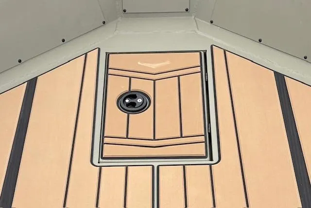 Slide: The Image of 2026 Tracker Grizzly 1756 T Marsh boat deck with sleek wood finish and hatch. - 15