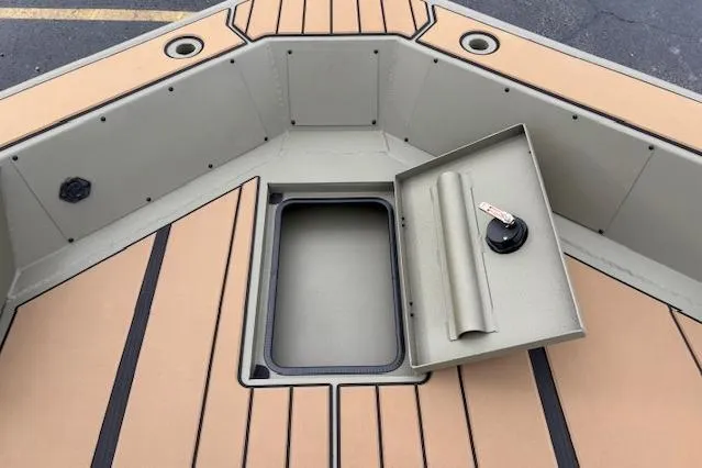 Slide: The Image of 2026 Tracker Grizzly 1756 T Marsh boat interior with open storage compartment. - 16