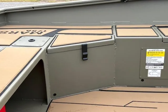 Slide: The Image of 2026 Tracker Grizzly 1756 T Marsh boat interior with storage compartments and safety label. - 18