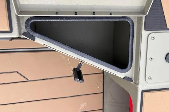 Slide: The Image of Storage compartment of 2026 Tracker Grizzly 1756 T Marsh boat, featuring secure latch. - 20