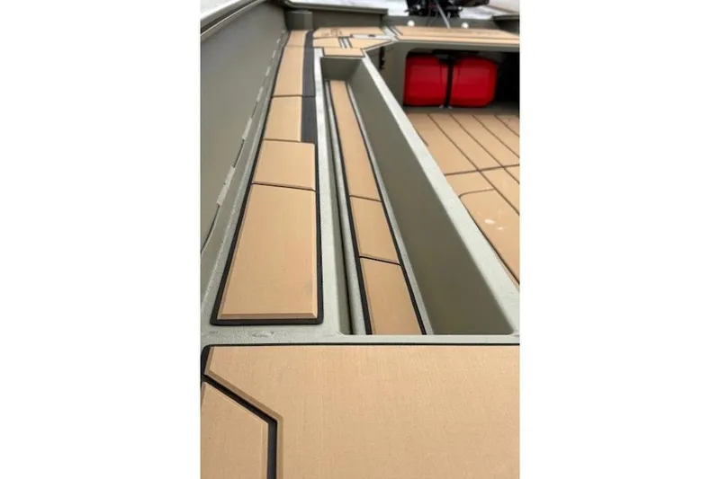 Slide: The Image of 2026 Tracker Grizzly 1756 T Marsh boat interior with tan decking and storage compartments. - 23