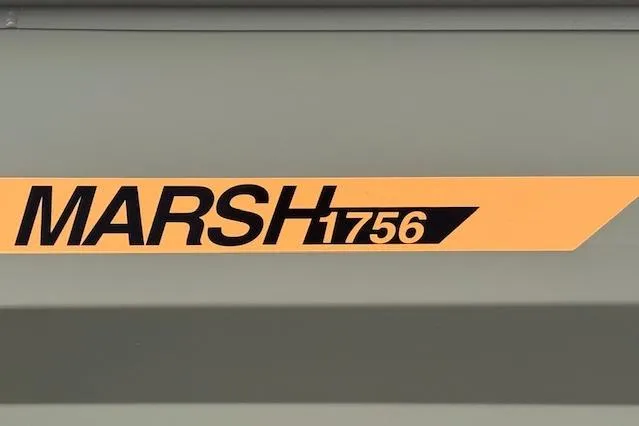 Slide: The Image of 2026 Tracker Grizzly 1756 T Marsh logo on a green surface. - 27