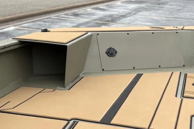 Slide: The Image of 2026 Tracker Grizzly 1756 T Marsh boat interior with storage compartment and non-slip flooring. - 33
