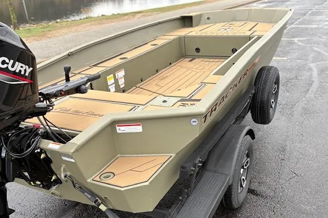 Slide: The Image of 2026 Tracker Grizzly 1756 T Marsh boat on trailer, featuring spacious deck and Mercury engine. - 36