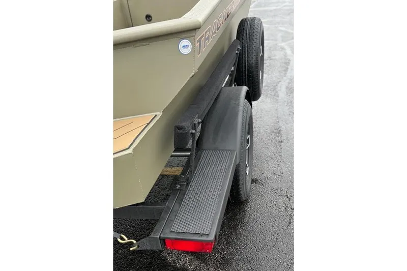 Slide: The Image of 2026 Tracker Grizzly 1756 T Marsh boat trailer detail on wet pavement. - 37