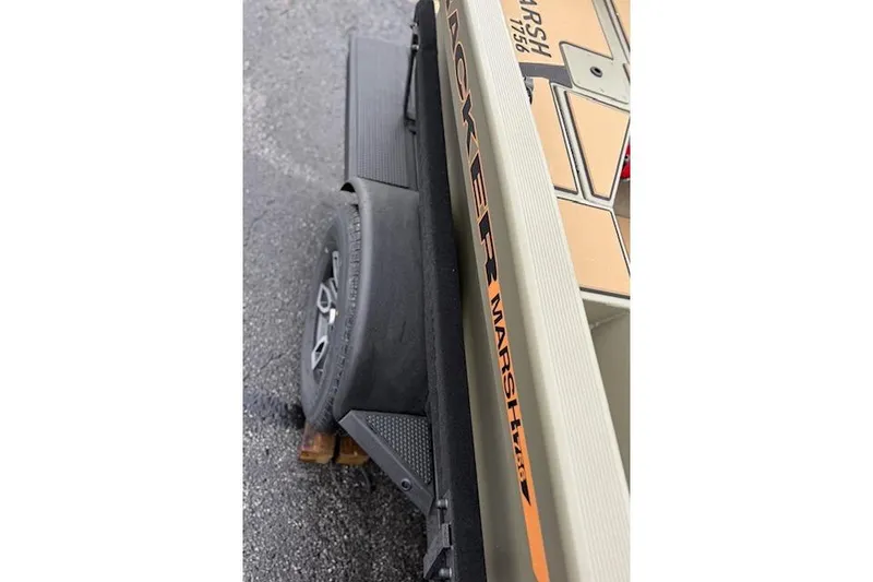 Slide: The Image of 2026 Tracker Grizzly 1756 T Marsh boat on trailer, showcasing side view and branding. - 38