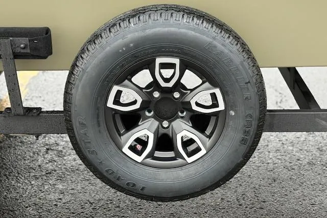 Slide: The Image of Trailer wheel of 2026 Tracker Grizzly 1756 T Marsh on asphalt surface. - 76