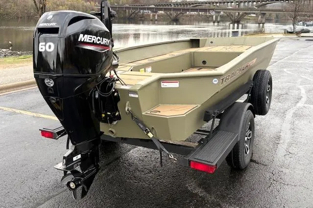 Slide: The Image of 2026 Tracker Grizzly 1756 T Marsh boat with Mercury 60 engine on trailer by river. - 8