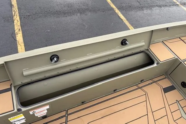 Slide: The Image of 2026 Tracker Grizzly 1756 T Marsh boat interior with storage compartment and non-slip flooring. - 80