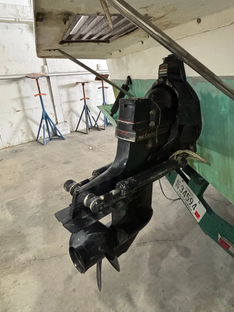 Slide: The Image of 1989 Sea Ray 290 Sundancer boat outdrive in a garage setting. - 8