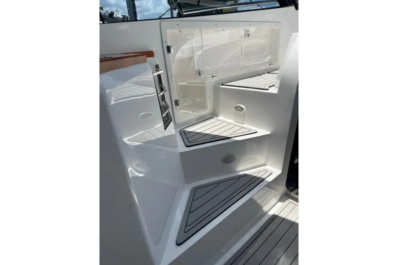Slide: The Image of Staircase on 2023 NX Boats NX360 with sleek design and storage compartment. - 16