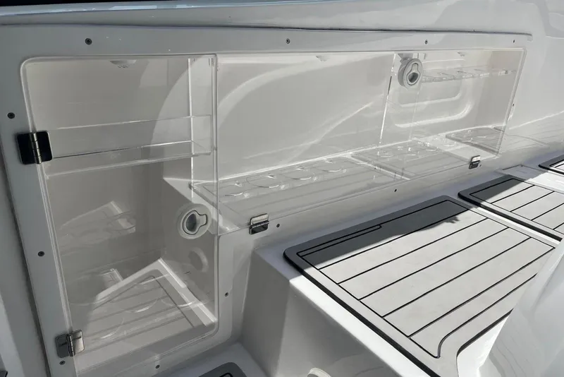 Slide: The Image of 2023 NX Boats NX360 interior storage compartment with sleek design and modern features. - 18