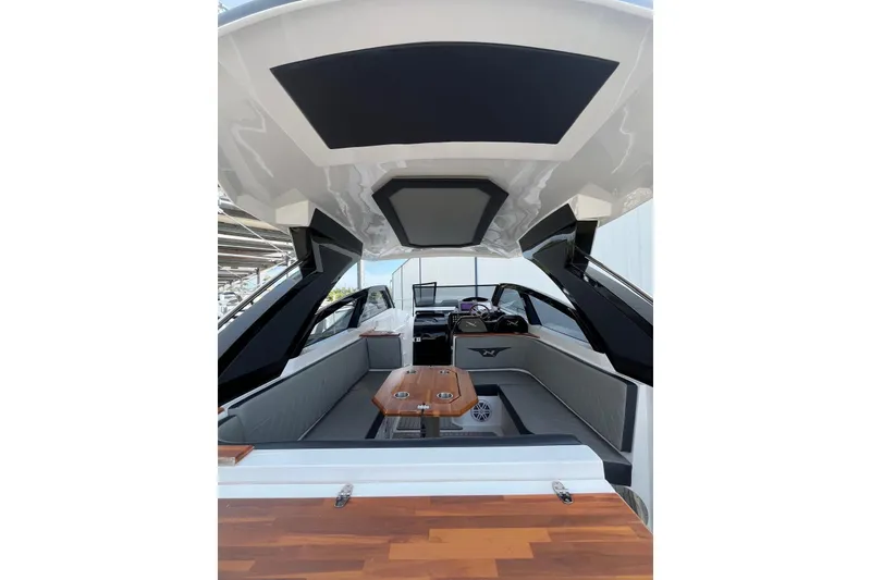 Slide: The Image of 2023 NX Boats NX360 interior with sleek design and wooden table. - 20