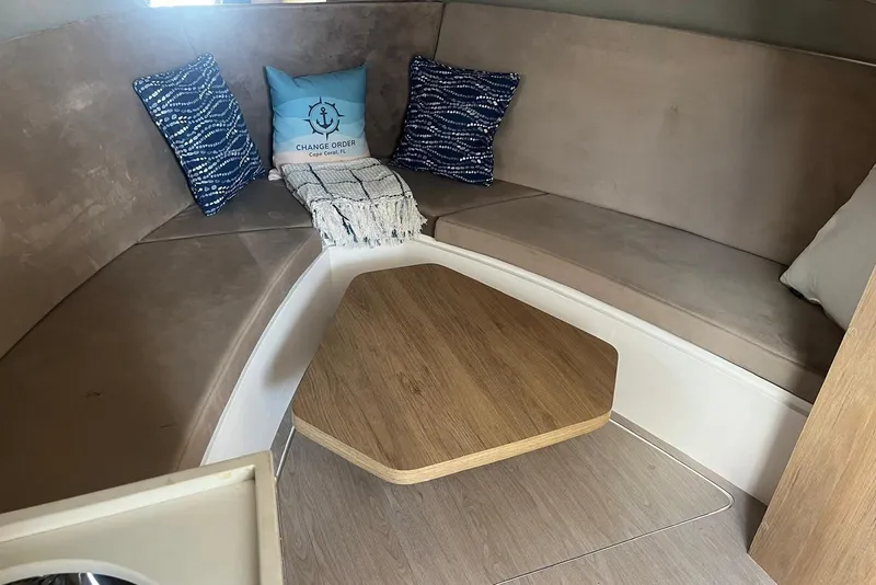 Slide: The Image of Interior of 2023 NX Boats NX360 with cozy seating and decorative pillows. - 22