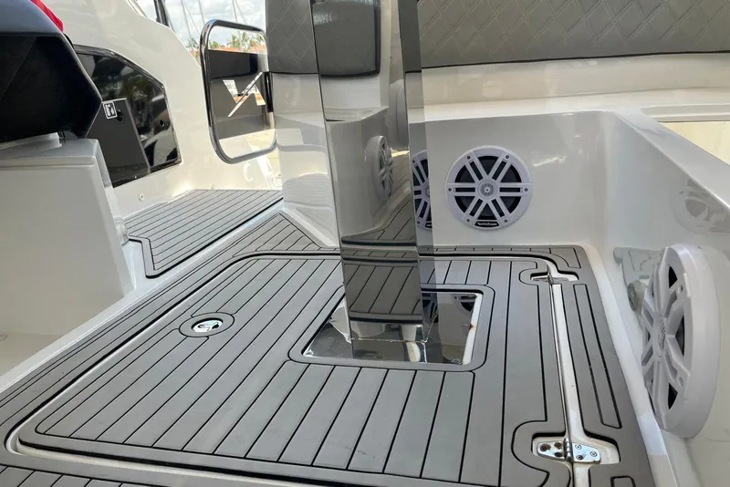 Slide: The Image of 2023 NX Boats NX360 interior with sleek flooring and built-in speakers. - 24