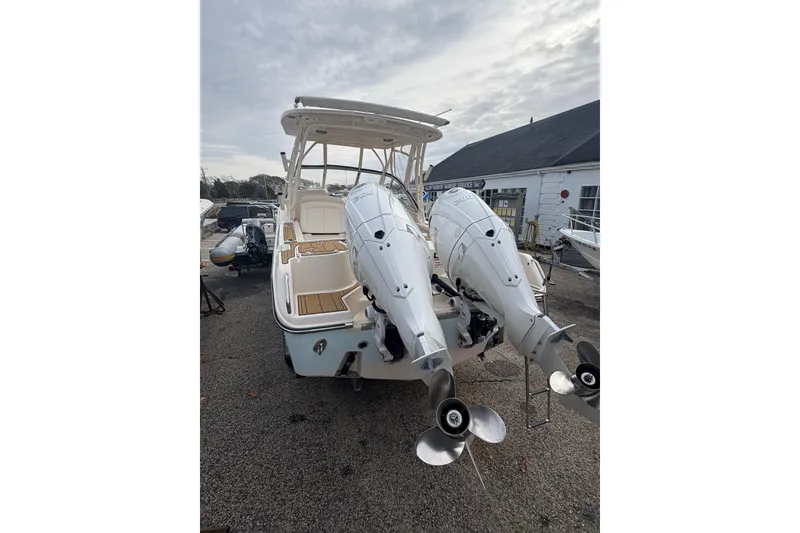 Slide: The Image of 2024 Grady-White Freedom 255 boat with dual outboard engines, parked outdoors. - 4