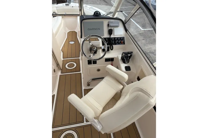 Slide: The Image of 2024 Grady-White Freedom 255 boat cockpit with Garmin navigation system and luxurious seating. - 8