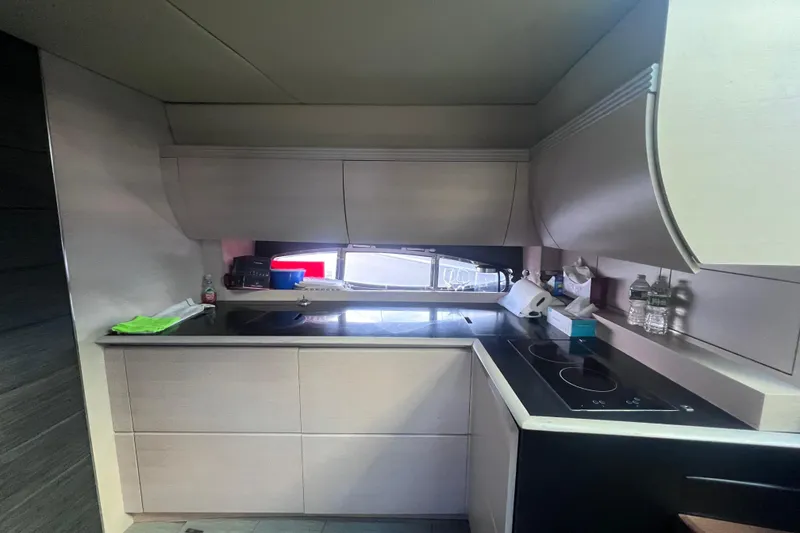 Slide: The Image of Modern kitchen interior on a 2006 Azimut Atlantis 55 yacht, featuring sleek cabinetry and appliances. - 10