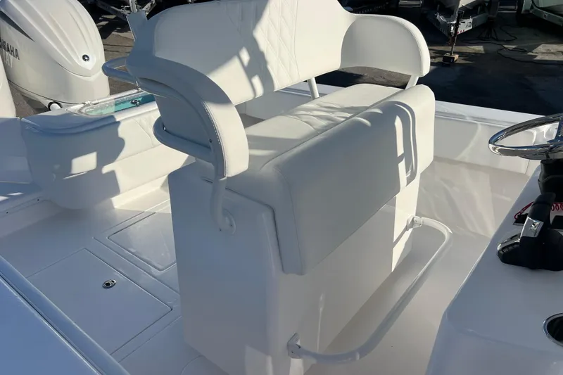 Slide: The Image of 2026 Contender 28 Tournament boat interior with white seating and steering wheel. - 17