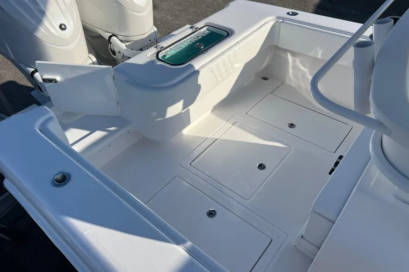 Slide: The Image of 2026 Contender 28 Tournament boat deck with storage compartments and twin engines. - 18