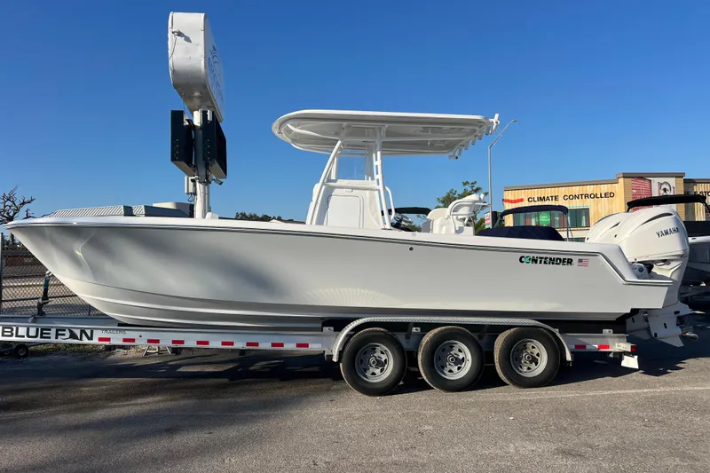 Slide: The Image of 2026 Contender 28 Tournament boat on trailer, side view, clear sky background. - 3