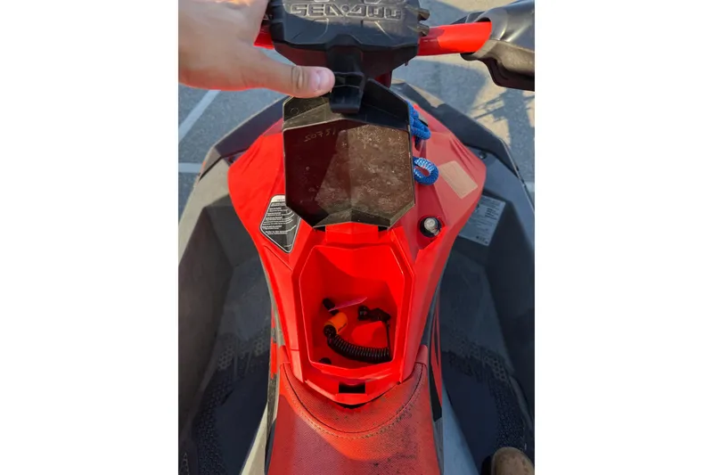 Slide: The Image of 2021 Sea-Doo Spark Trixx 2up, red dashboard view with storage compartment open. - 10