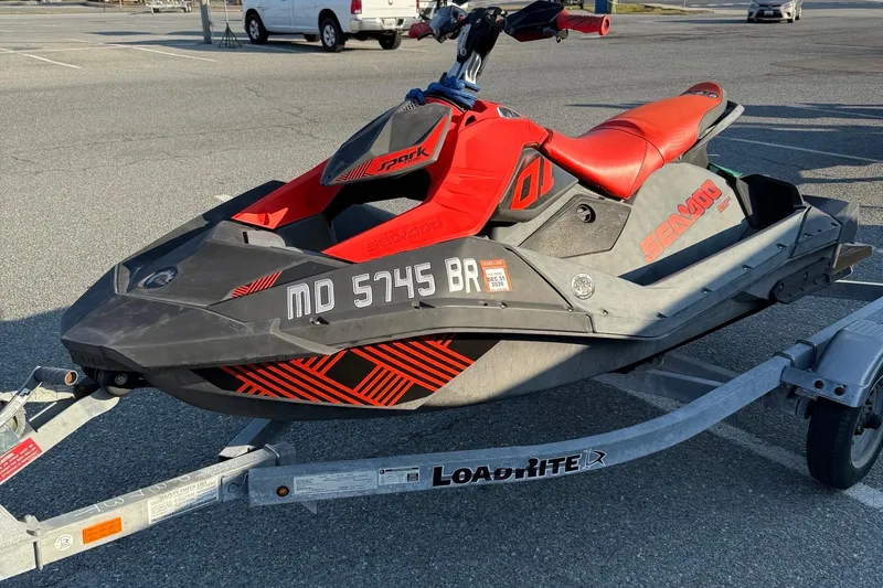 Slide: The Image of 2021 Sea-Doo Spark Trixx 2up jet ski on trailer in parking lot. - 4