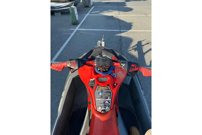 Slide: The Image of 2021 Sea-Doo Spark Trixx 2up jet ski parked in a lot, top view. - 9