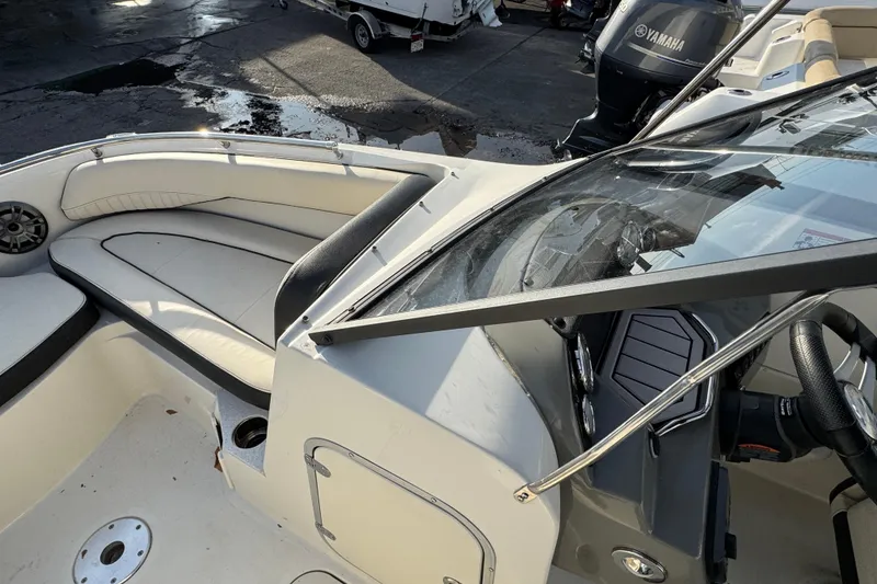 Slide: The Image of 2021 Stingray 201 DC boat interior with seating and dashboard view. - 10