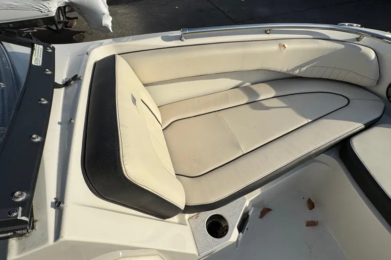 Slide: The Image of 2021 Stingray 201 DC boat interior with beige seating and black trim. - 11