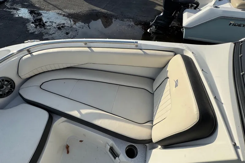 Slide: The Image of 2021 Stingray 201 DC boat interior with white cushioned seating and speaker. - 12