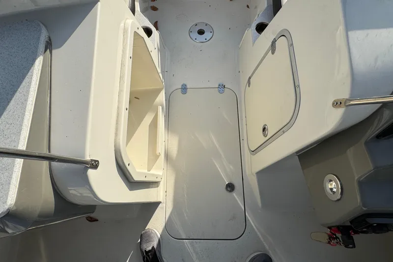 Slide: The Image of Interior view of a 2021 Stingray 201 DC boat, showcasing storage compartments. - 15