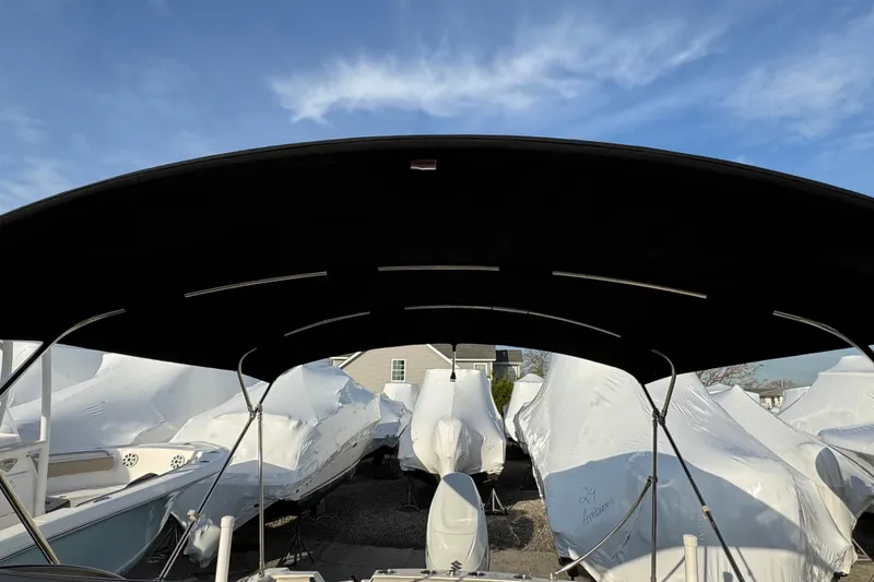 Slide: The Image of Covered boats in storage, viewed from a 2021 Stingray 201 DC. - 18